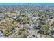 An aerial view of two homes in a tree-filled neighborhood, with a pond visible in the background at 1800 27Th N Ave, St Petersburg, FL 33713