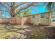 Backyard featuring mature trees, wood fences and green grass at 1800 27Th N Ave, St Petersburg, FL 33713