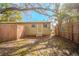 Backyard featuring mature trees, wood fences and green grass at 1800 27Th N Ave, St Petersburg, FL 33713