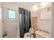 Bathroom featuring tiled walls, shower curtain and accessible toilet at 1800 27Th N Ave, St Petersburg, FL 33713