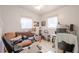 Bedroom showcasing a cozy futon, computer desk, and bright natural light at 1800 27Th N Ave, St Petersburg, FL 33713