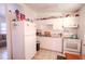 Compact kitchen with white cabinetry, tile flooring, and essential appliances at 1800 27Th N Ave, St Petersburg, FL 33713