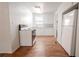 Functional kitchen featuring clean appliances, white cabinetry, and ample natural light from the window at 1800 27Th N Ave, St Petersburg, FL 33713