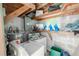 Indoor laundry area with washer, dryer, shelving, and gray concrete walls at 1800 27Th N Ave, St Petersburg, FL 33713