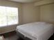 Bright bedroom with hardwood floors and a large window, offering a comfortable and serene space at 18106 Peregrines Perch Pl # 5208, Lutz, FL 33558