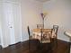 Cozy dining area with a round table, adjacent to a closet and kitchen, with hardwood flooring at 18106 Peregrines Perch Pl # 5208, Lutz, FL 33558