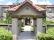 Inviting entrance walkway leading to a multi-story building with lush landscaping at 18106 Peregrines Perch Pl # 5208, Lutz, FL 33558