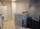 Efficient kitchen with a breakfast bar, ample counter space, white appliances, and nearby dining area at 18106 Peregrines Perch Pl # 5208, Lutz, FL 33558