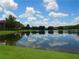 Beautiful lake view reflecting the sky and surrounding trees, offering a peaceful vista at 18106 Peregrines Perch Pl # 5208, Lutz, FL 33558
