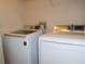 Convenient laundry area featuring a white Samsung front-load washer and dryer at 18106 Peregrines Perch Pl # 5208, Lutz, FL 33558