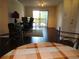 Comfortable living space with a dining area and desk setup, offering a view from the sliding glass doors at 18106 Peregrines Perch Pl # 5208, Lutz, FL 33558
