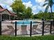 Community pool with lounge chairs surrounding the pool at 18106 Peregrines Perch Pl # 5208, Lutz, FL 33558