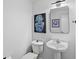 This half bathroom features a sleek sink and toilet, with modern artwork at 226 5Th N Ave # 1203, St Petersburg, FL 33701