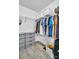 Walk-in closet with wire shelving and storage bins for organized storage at 2441 Blossom Lake Dr, Holiday, FL 34691