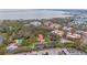 Aerial view of complex including the pool, parking lot, and waterfront view at 2699 Seville Blvd # 208, Clearwater, FL 33764