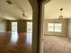 Spacious living room featuring beautiful floors, ceiling fan, and sliding glass doors to the outside at 27901 Pleasure Ride Loop, Wesley Chapel, FL 33544