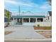 Charming home with a bright blue trim, white privacy fence, inviting entrance, and updated windows offering curb appeal at 3018 Highland N St, St Petersburg, FL 33704