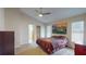 Large main bedroom with high ceilings, fan, painting, and a cozy bed at 3018 Highland N St, St Petersburg, FL 33704