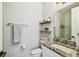 Well-appointed half bathroom with floating shelves, granite vanity, and modern fixtures at 3505 S Macdill Ave # 4, Tampa, FL 33629