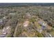 Aerial view of the house situated amidst lush greenery and trees in a tranquil and picturesque setting at 3512 Kalebs Forest Trl, Dover, FL 33527