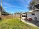 Expansive backyard featuring a picnic table, well-manicured lawn, and a screened patio for outdoor enjoyment at 5200 Queen N St, St Petersburg, FL 33714