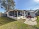 Lovely backyard featuring a screened patio, a picnic table, and a well-maintained lawn, creating a relaxing outdoor space at 5200 Queen N St, St Petersburg, FL 33714