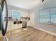 The bright kitchen features white cabinets, a stainless sink and appliances, and luxury vinyl floors at 5200 Queen N St, St Petersburg, FL 33714