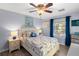Serene bedroom with nautical decor, a comfortable bed, and natural light from a large window at 5202 Beach Se Dr # C, St Petersburg, FL 33705