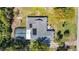Aerial view showcasing the home's roof, screened pool enclosure, and surrounding landscape at 5253 Sandra Dr, Weeki Wachee, FL 34607