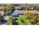 Expansive aerial view of a well-maintained home with a lush, green yard and mature trees at 5253 Sandra Dr, Weeki Wachee, FL 34607