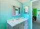 Stylish bathroom with a gray vanity, white countertop, and modern accents at 5253 Sandra Dr, Weeki Wachee, FL 34607