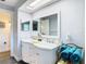 Bathroom featuring a double sink vanity with granite counters, large mirror and modern finishes at 5253 Sandra Dr, Weeki Wachee, FL 34607