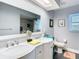 Bathroom featuring a double sink vanity with granite counters, large mirror and modern finishes at 5253 Sandra Dr, Weeki Wachee, FL 34607