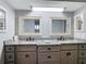 Bathroom featuring double sink with granite countertop and matching framed mirrors at 5253 Sandra Dr, Weeki Wachee, FL 34607