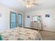 Bright bedroom with a ceiling fan, a dresser, and french doors leading to the outside at 5253 Sandra Dr, Weeki Wachee, FL 34607