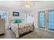 Bright bedroom with a ceiling fan, a dresser, and french doors leading to the outside at 5253 Sandra Dr, Weeki Wachee, FL 34607