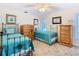 Charming bedroom with twin beds, soft carpet, and natural light at 5253 Sandra Dr, Weeki Wachee, FL 34607