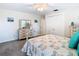 Comfortable bedroom features a ceiling fan, closet, and dresser with light walls and carpeted floor at 5253 Sandra Dr, Weeki Wachee, FL 34607