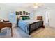 This is a bedroom with a large bed, several pictures hanging on the wall, and a desk and chair at 5253 Sandra Dr, Weeki Wachee, FL 34607