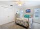 Bright bedroom with a ceiling fan, a dresser, and closet doors at 5253 Sandra Dr, Weeki Wachee, FL 34607