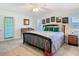 Bedroom featuring an ornate wood bedframe, ceiling fan, and a door leading outside at 5253 Sandra Dr, Weeki Wachee, FL 34607