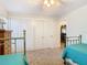 Bright bedroom featuring twin beds, neutral carpet, and access to additional rooms at 5253 Sandra Dr, Weeki Wachee, FL 34607
