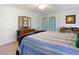 Bedroom featuring an ornate wood bedframe, ceiling fan, and a dresser with mirror at 5253 Sandra Dr, Weeki Wachee, FL 34607