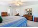 Bright bedroom with wood dresser, ceiling fan, and ensuite bathroom and dining room access at 5253 Sandra Dr, Weeki Wachee, FL 34607
