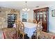 The dining area features a china cabinet, dining table, and stone accent wall at 5253 Sandra Dr, Weeki Wachee, FL 34607