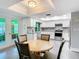 Bright kitchen featuring stainless steel appliances, granite countertops, and a cozy breakfast nook at 5253 Sandra Dr, Weeki Wachee, FL 34607