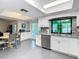 The open kitchen features white cabinets, granite countertops, stainless steel appliances and eat in dining at 5253 Sandra Dr, Weeki Wachee, FL 34607