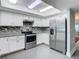 The kitchen features stainless appliances, granite counters and white cabinets at 5253 Sandra Dr, Weeki Wachee, FL 34607