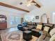 Inviting living room featuring a comfortable leather sectional sofa, wooden beams, and hardwood floors at 5253 Sandra Dr, Weeki Wachee, FL 34607