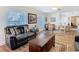 Bright and airy living room with a leather sofa, hardwood floors, and great natural light at 5253 Sandra Dr, Weeki Wachee, FL 34607